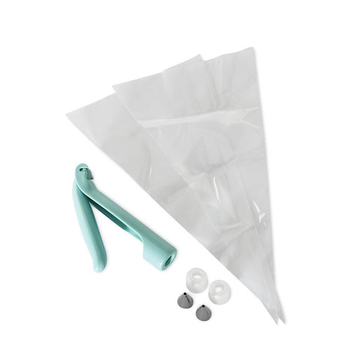 A set of cake decorating tools including an icing pen, a clear piping bag, and small decorating tips.
