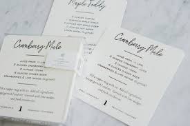 Recipes for drinks on white coasters.