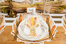 An autumn themed table display with gold utensils and harvest accents.