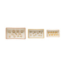 A set of three beige stoneware ramekins with a floral pattern, each with a different size.