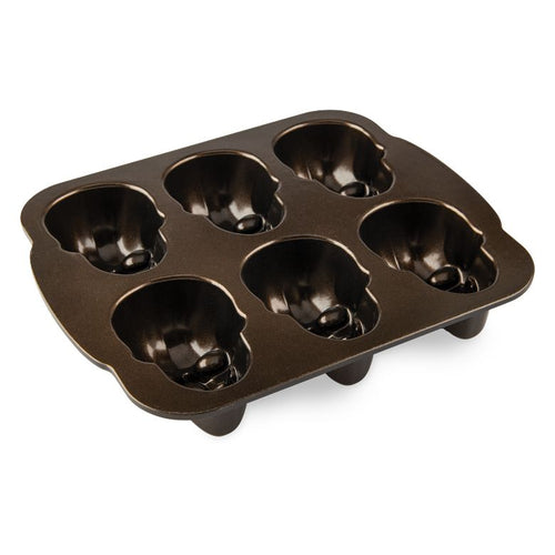 A pan with six skull-shaped cake molds in a grid arrangement.