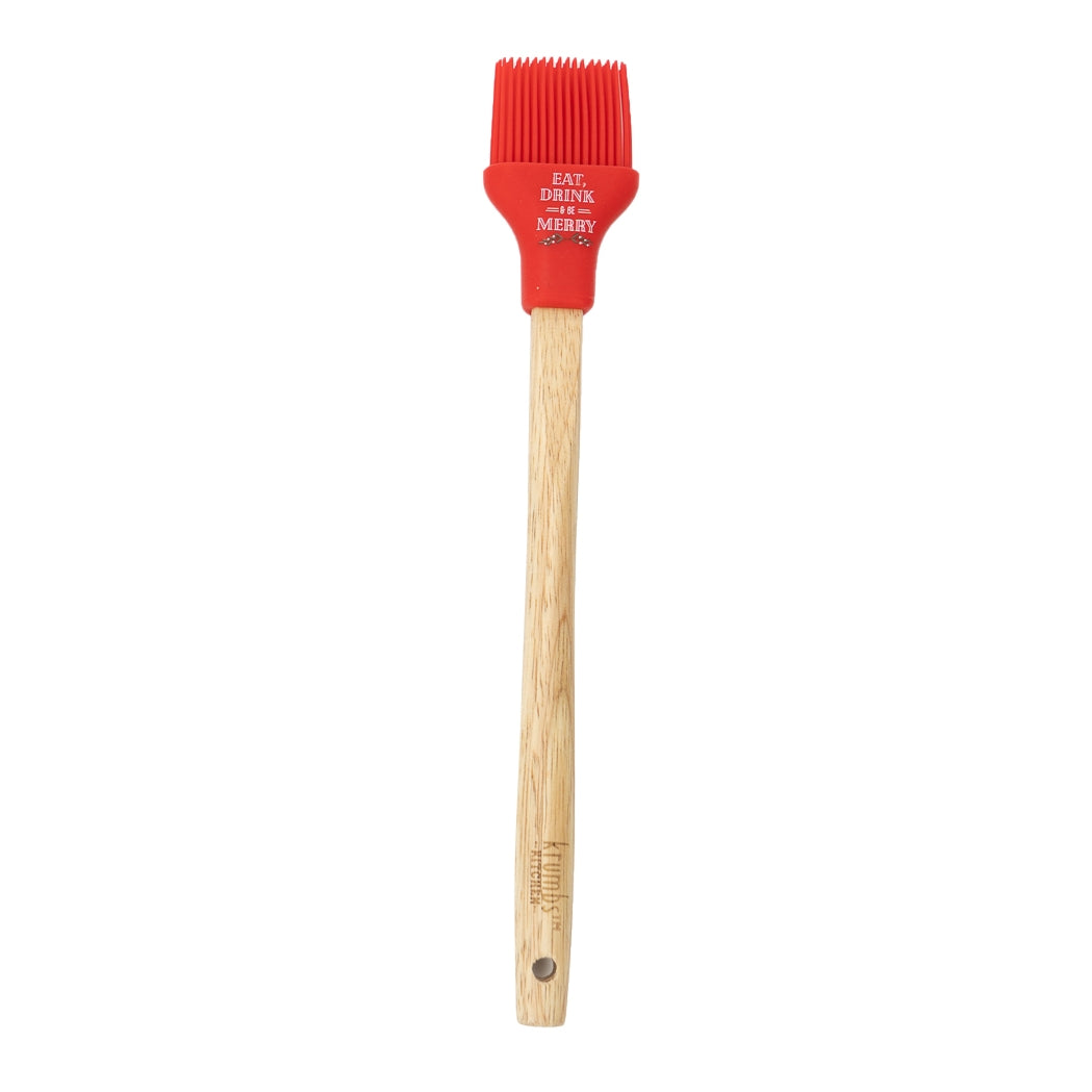 Basting brush with wooden handle and red silicone head with 'eat, drink, and be merry' phrase.