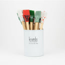 A set of basting brushes with wooden handles and multicolored silicone heads displayed in a white tin with the brand name 'krumbs' on the front.