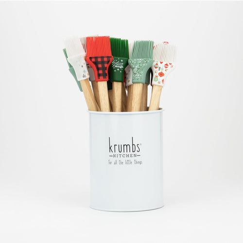 A set of basting brushes with wooden handles and multicolored silicone heads displayed in a white tin with the brand name 'krumbs' on the front.