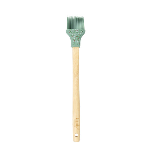 Basting brush with wooden handle and green silicone head with holly design.