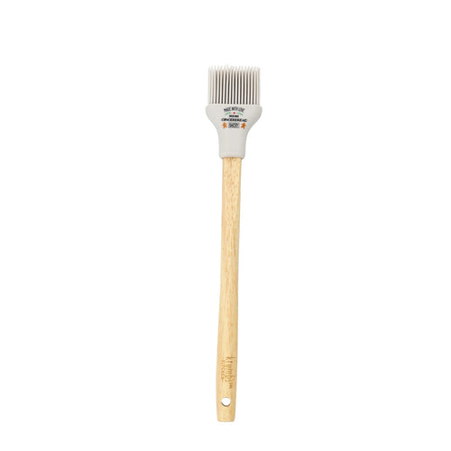 Basting brush with wooden handle and white silicone head with holiday phrase on it.