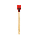 Basting brush with wooden handle and red silicone head with black plaid pattern.