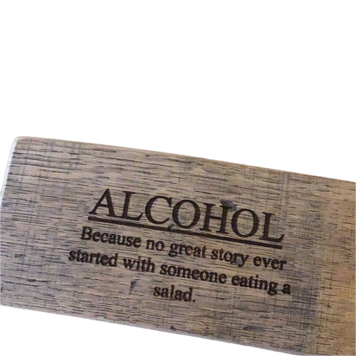 Wooden sign with humorous text about alcohol and stories