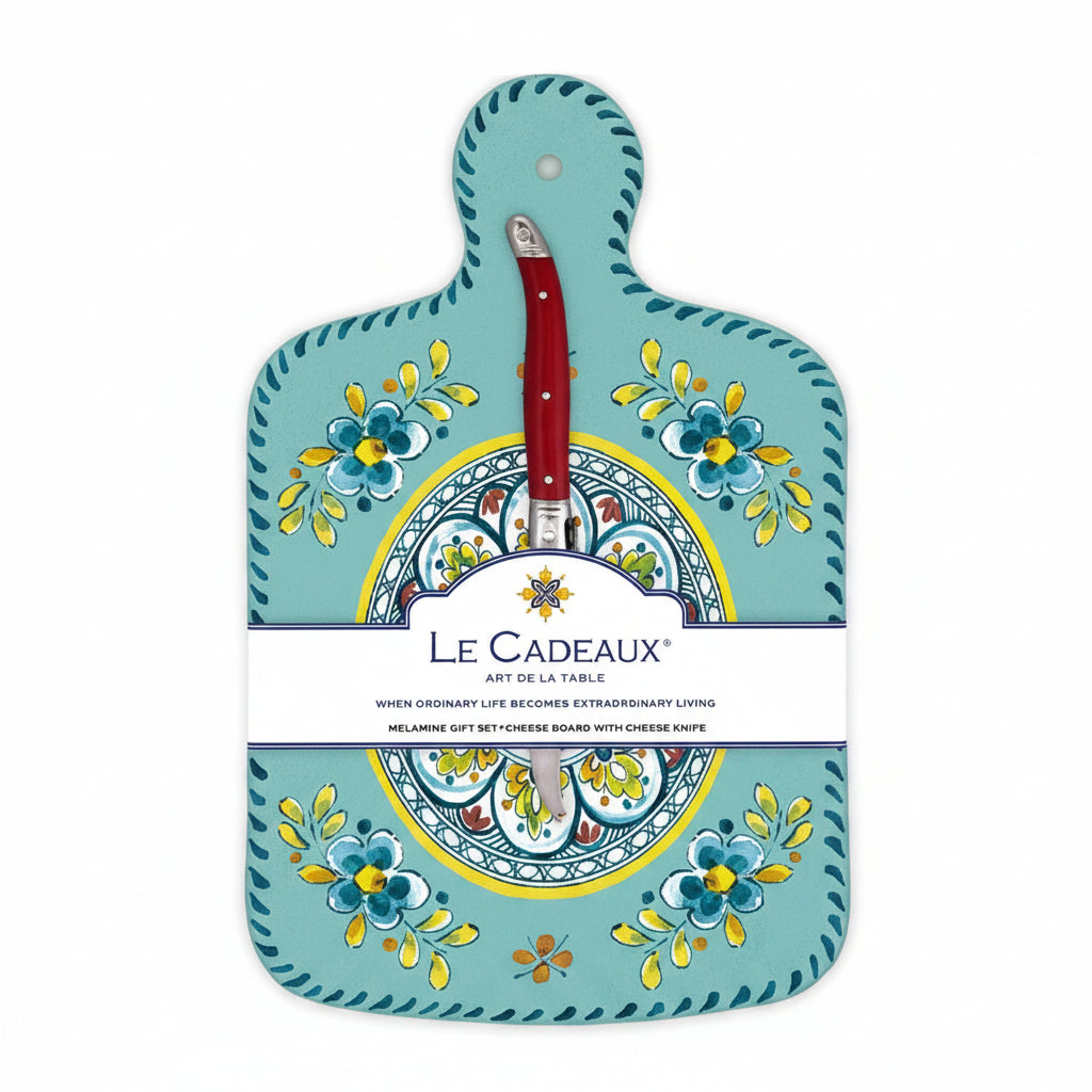 A turquoise cheese board with a floral pattern and a brown knife attached to it, packaged with a label displaying the brand name and product details.