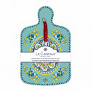 A turquoise cheese board with a floral pattern and a brown knife attached to it, packaged with a label displaying the brand name and product details.