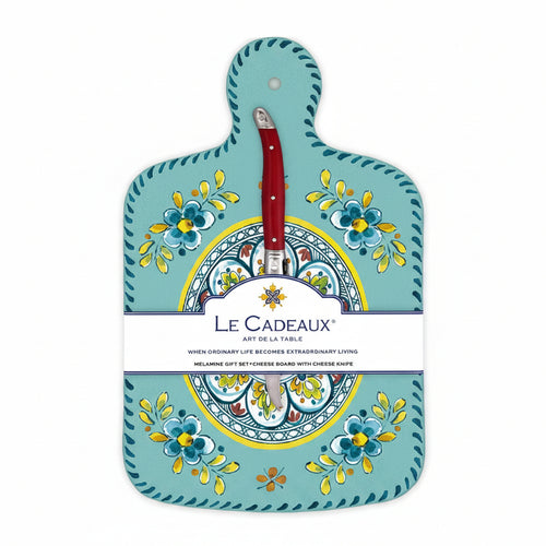 A turquoise cheese board with a floral pattern and a brown knife attached to it, packaged with a label displaying the brand name and product details.
