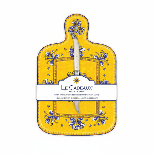 A yellow cheese board with a blue, white, and yellow floral pattern and a white handled knife attached to it, packaged with a label displaying the brand name and product details.