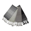 A set of four striped kitchen tea towels in gray, black, white, and green colors with textured braided tassels on the bottom.