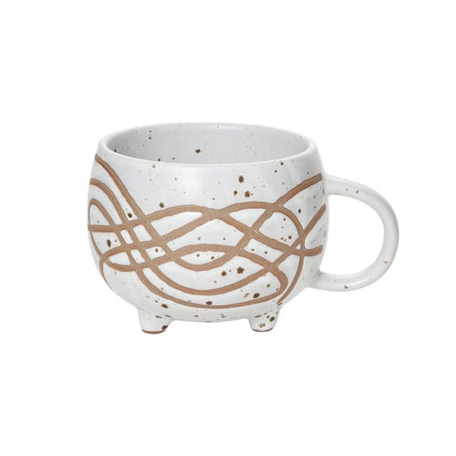 A beige and white speckled ceramic mug with an ergonomic handle, suitable for holding milk or sugar.