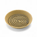 A stainless steel pie weight chain coiled inside of a pie crust on a white background.