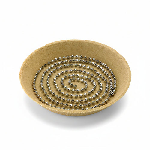 A stainless steel pie weight chain coiled inside of a pie crust on a white background.