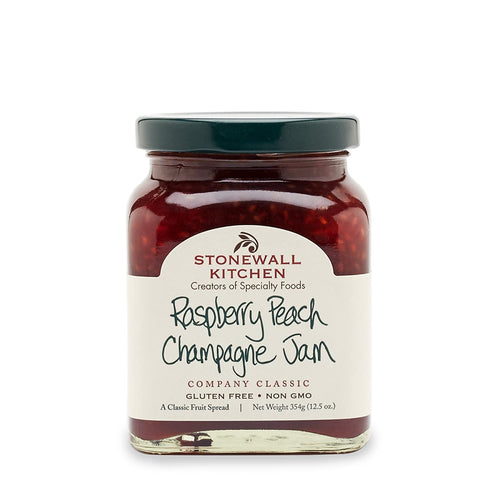 A jar of Stonewall Kitchen Raspberry Peach Champagne Jam with the label clearly showing the product name and brand.