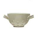 A round, white stoneware berry bowl with reactive glaze and handles on the sides.