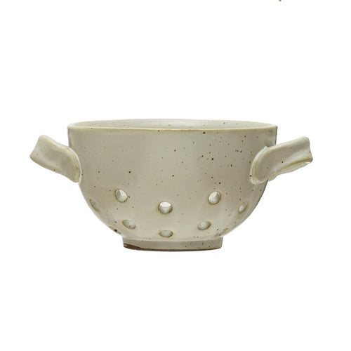 A round, white stoneware berry bowl with reactive glaze and handles on the sides.
