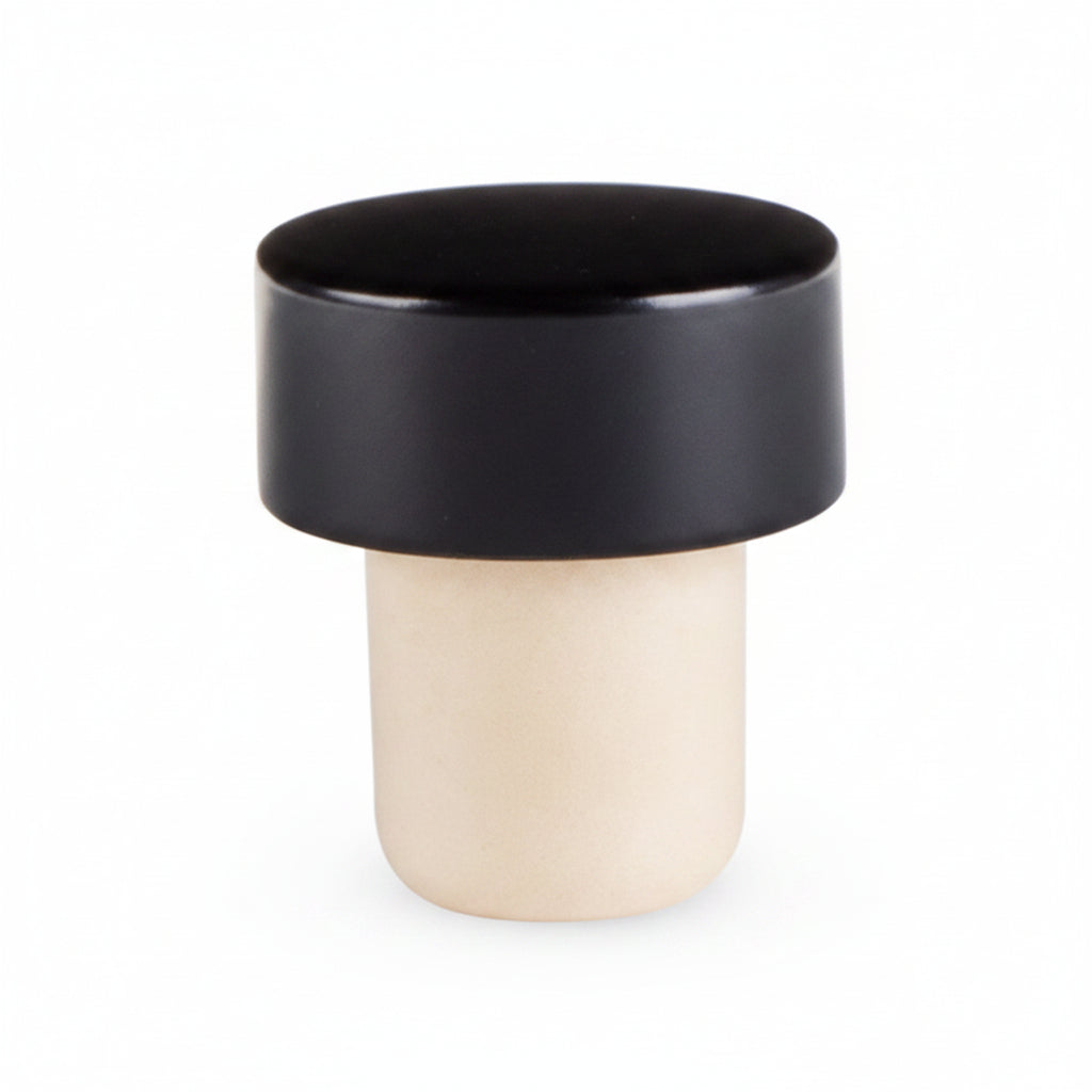 A solid black bottle stopper with a smooth finish, designed to fit standard bottles.