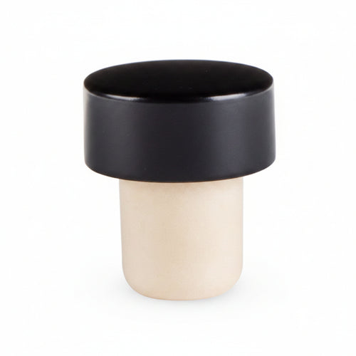 A solid black bottle stopper with a smooth finish, designed to fit standard bottles.