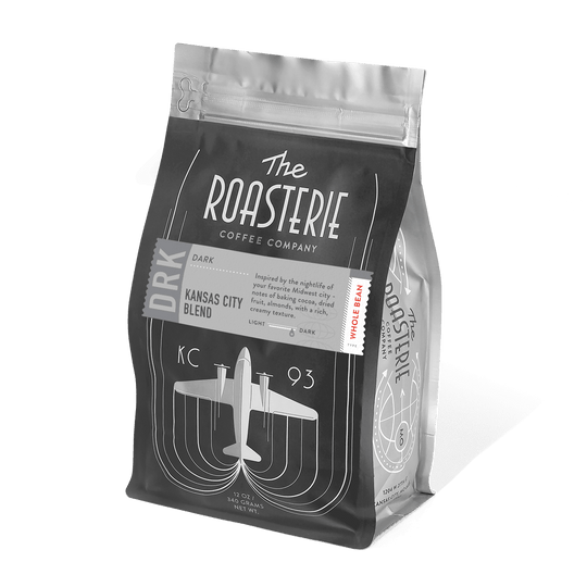 A pack of The Roasterie Kansas City Dark Coffee, showing the brand logo, and the type of coffee.
